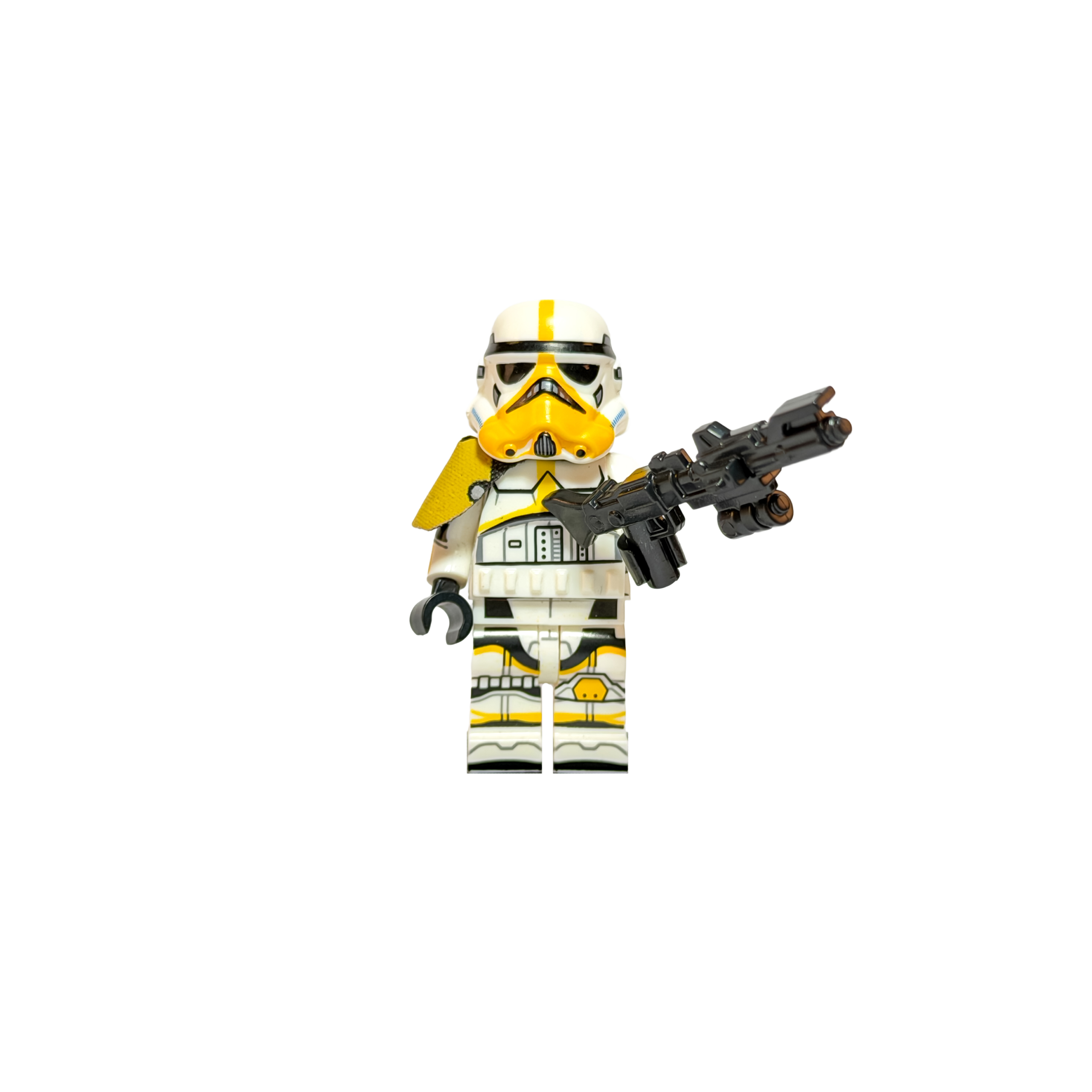 Minifigura de colección de un Mortar Trooper (Stormtrooper Artillero) sobre un fondo negro puro. La armadura es blanca con marcas tácticas amarillas en el casco, torso y piernas. Destaca una hombrera de tela amarilla en su hombro derecho. Sostiene un rifle bláster negro largo hacia un costado en una pose de combate firme.